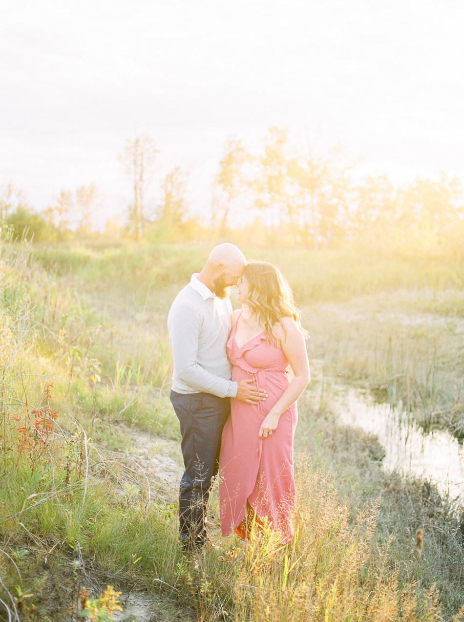 Fine Art Wedding Photographer Esther Funk Photography | A Semi Formal Birds Hill Provincial Park Engagement Session | A couple cuddling during Golden Hour | She is wearing a rose coloured dress