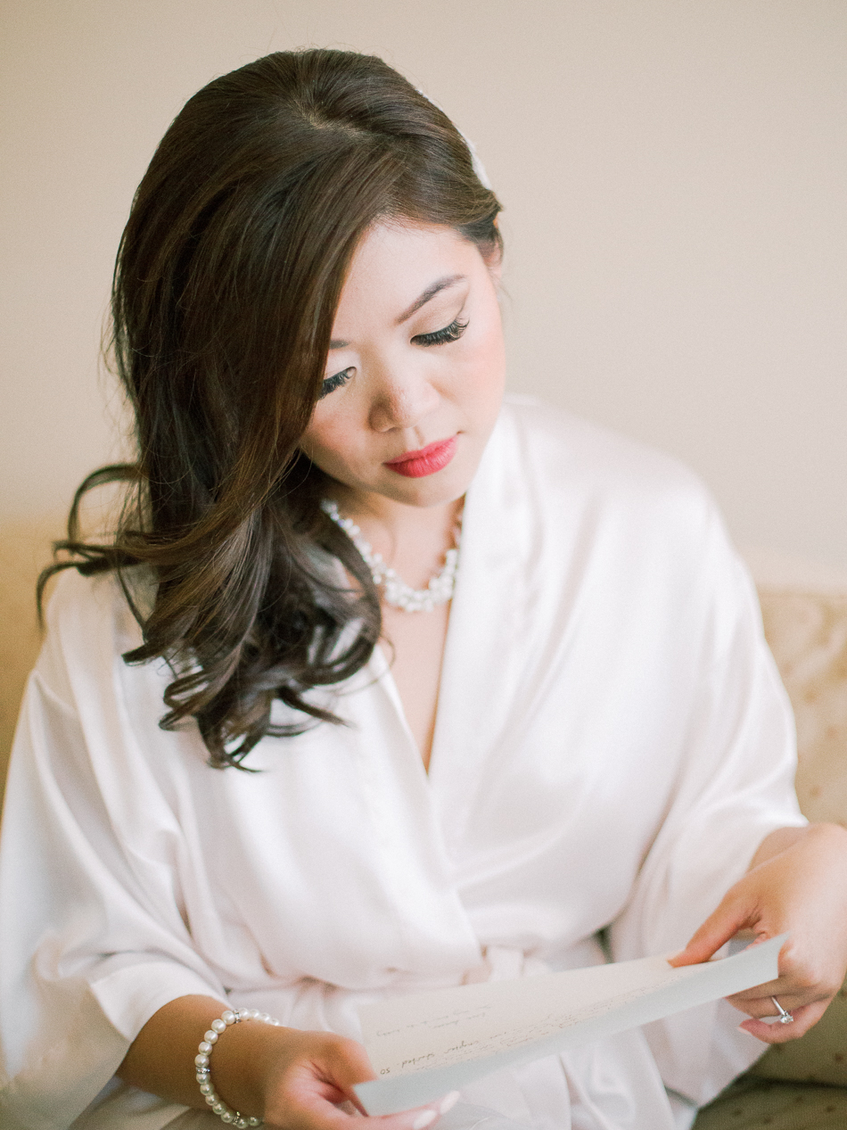 Minimalist Modern Winnipeg Wedding | Photographed by Esther Funk Photography | Winnipeg Country Club Wedding | St. Charles Country Club Wedding | Bridal Getting Ready | Bride reading letter from groom | Bridal Suite